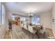 Dining room open to kitchen area, set for a meal, showcasing an open-concept design at 3204 Romanesque Art Ave, Henderson, NV 89044