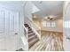 Charming entryway showcasing staircase and wood-look flooring, leading into an inviting living space at 3204 Romanesque Art Ave, Henderson, NV 89044