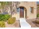 Close-up of the front entrance featuring a dark wood door, with a well kept walkway and landscaping at 3204 Romanesque Art Ave, Henderson, NV 89044