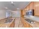 Open kitchen with granite countertops, stainless steel appliances, and wood-style flooring at 3204 Romanesque Art Ave, Henderson, NV 89044