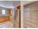 Kitchen featuring a stainless steel refrigerator, ample cabinet space, and a pantry with shelving at 3204 Romanesque Art Ave, Henderson, NV 89044