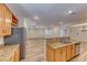 A spacious kitchen with stainless steel appliances and granite countertops overlooking the living area at 3204 Romanesque Art Ave, Henderson, NV 89044