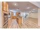 Spacious open kitchen and living area featuring stainless steel appliances and wood-style flooring at 3204 Romanesque Art Ave, Henderson, NV 89044