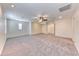 A large living area featuring carpet flooring, ceiling fan, recessed lighting and plantation shutters at 3204 Romanesque Art Ave, Henderson, NV 89044