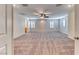 Spacious and bright living room featuring carpet floors, ceiling fan, recessed lighting, and natural light at 3204 Romanesque Art Ave, Henderson, NV 89044