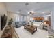 Bright living room with plantation shutters, neutral furniture, and an open layout flowing into the kitchen at 3204 Romanesque Art Ave, Henderson, NV 89044