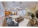 Spacious living room features plantation shutters, stylish decor, and seamless transition to the kitchen at 3204 Romanesque Art Ave, Henderson, NV 89044