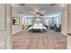 Spacious main bedroom with plush carpeting, ceiling fan, and windows with shutters allowing for natural light at 3204 Romanesque Art Ave, Henderson, NV 89044