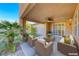 Relaxing covered patio featuring comfortable seating, ideal for outdoor enjoyment and entertainment at 3204 Romanesque Art Ave, Henderson, NV 89044