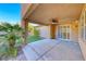 Covered patio overlooking artificial grass, a palm tree and blue skies at 3204 Romanesque Art Ave, Henderson, NV 89044