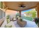 Inviting covered patio with plush seating, ideal for outdoor gatherings, overlooking a lush landscaped backyard at 3204 Romanesque Art Ave, Henderson, NV 89044