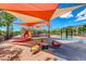 Vibrant community playground with colorful play structures, shade canopies, and soft ground surfaces for safety at 3204 Romanesque Art Ave, Henderson, NV 89044