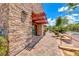 Attractive storefront with stone facade, trellis, and brick walkway leading to outdoor restaurant seating at 3204 Romanesque Art Ave, Henderson, NV 89044