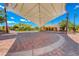 Open-air town square with shade structure, brick paving, and accessible walkways, perfect for community events at 3204 Romanesque Art Ave, Henderson, NV 89044