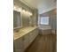 Bathroom featuring a double vanity with white cabinets and bright lighting at 3304 Michelangelo Ct, Las Vegas, NV 89129