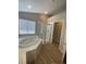 Bathroom featuring a soaking tub, a walk-in shower, and neutral flooring at 3304 Michelangelo Ct, Las Vegas, NV 89129