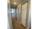 Hallway featuring beige walls and white storage cabinets on the wall at 3304 Michelangelo Ct, Las Vegas, NV 89129