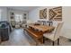 Comfortable dining area with a long wooden table, bench, and decorative wall art at 3503 Luca Point Ave, Henderson, NV 89044