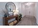 Bright entryway with wood floors, console table, decorative mirror, and white double doors at 3503 Luca Point Ave, Henderson, NV 89044