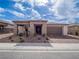 A well-maintained single-story home with neutral tones, rock landscaping, and a two-car garage at 3503 Luca Point Ave, Henderson, NV 89044