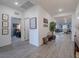 Inviting hallway leading to the open living space with stylish decor and modern wood-look tile flooring at 3503 Luca Point Ave, Henderson, NV 89044