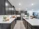 Stylish kitchen featuring dark wood cabinets, stainless steel appliances, and a large center island at 3503 Luca Point Ave, Henderson, NV 89044