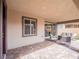 Comfortable covered patio with brick flooring and cozy outdoor seating area at 3503 Luca Point Ave, Henderson, NV 89044