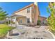 Backyard with covered patio, stone accents, manicured lawn, and mature landscaping at 3658 Ambergate Ct, Las Vegas, NV 89147