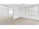 Neutral bedroom featuring a window, carpet and a mirrored closet at 3658 Ambergate Ct, Las Vegas, NV 89147