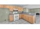 Well-lit kitchen featuring white appliances, wood cabinets, and a granite countertop at 3658 Ambergate Ct, Las Vegas, NV 89147