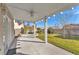 Covered patio features a fan, white support beams, concrete flooring, and backyard views at 3658 Ambergate Ct, Las Vegas, NV 89147