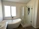 Bathroom showcasing a soaking tub, walk-in shower, and modern fixtures at 3751 Morning Canyon St, Las Vegas, NV 89147