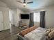 Bedroom with hardwood floors, a ceiling fan, and a sitting area with a TV at 3751 Morning Canyon St, Las Vegas, NV 89147