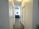 Hallway with modern flooring that leads to a bathroom at 3751 Morning Canyon St, Las Vegas, NV 89147