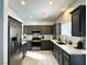 Beautiful kitchen featuring gray cabinets, stainless steel appliances, and quartz countertops at 3751 Morning Canyon St, Las Vegas, NV 89147