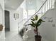 A staircase features white risers, a plant and modern decor at 3751 Morning Canyon St, Las Vegas, NV 89147