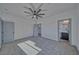 Well-lit bedroom with plush gray carpeting, a modern ceiling fan, and an attached bathroom at 376 E Erin St # 1, Pahrump, NV 89048