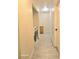 Hallway with wood-look tile floors and white walls, including a washer and dryer at 4006 Morning Peace St, Las Vegas, NV 89115