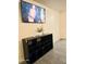 Bright living room with a TV and a black cabinet beneath it and ceramic floors at 4006 Morning Peace St, Las Vegas, NV 89115