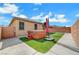 Backyard featuring artificial grass, covered hot tub, and privacy walls at 4340 Hatch Bend Ave, North Las Vegas, NV 89031