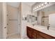 Bathroom featuring a double vanity with dark wood cabinets and a large mirror above, complemented by stylish lighting fixtures at 4340 Hatch Bend Ave, North Las Vegas, NV 89031