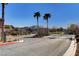 Gated community entrance with palm trees, landscaping, and a secure entry point for residents at 4340 Hatch Bend Ave, North Las Vegas, NV 89031