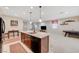 Open-concept kitchen features an island with granite countertops and a sink, seamlessly flowing into the living area at 4340 Hatch Bend Ave, North Las Vegas, NV 89031