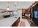 Bright kitchen with stone countertops, stainless steel appliances, and an island overlooking the game room at 4340 Hatch Bend Ave, North Las Vegas, NV 89031