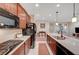 Modern kitchen features granite countertops, stainless appliances and connection to an open-plan living area at 4340 Hatch Bend Ave, North Las Vegas, NV 89031