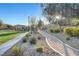 Scenic walking path with lush greenery, trees, and sunlight shining through the trees in the community at 4340 Hatch Bend Ave, North Las Vegas, NV 89031