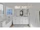 Bright bathroom features double vanity, soaking tub and white marble accents at 436 Trevinca St, Las Vegas, NV 89138