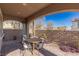 Charming covered patio with brick flooring, outdoor dining set, and views of the backyard at 436 Trevinca St, Las Vegas, NV 89138