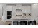 Kitchen island features granite countertops, stainless steel appliances, and white cabinets at 436 Trevinca St, Las Vegas, NV 89138