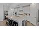 Open kitchen with white cabinets, granite counters, and island with bar seating at 436 Trevinca St, Las Vegas, NV 89138